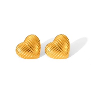 Detailed view of golden heart-shaped titanium steel earrings with radial texture