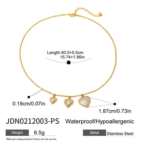 Detail of two-tone heart pendant necklace in stainless steel with measurement markings