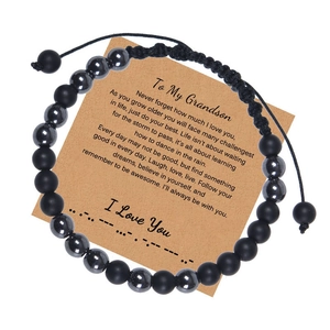 Close-up of matte black beads bracelet with Morse code message card for grandson