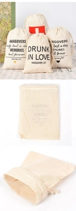 Macro shot of cotton linen hangover kit bags with red cross print for wedding favors