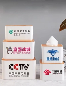 Detailed view of various tissue box models with wood lids and custom printed brand logos