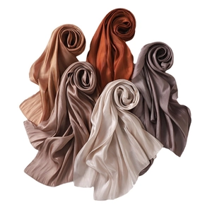 Satin silk shawls in multiple earth tones featuring soft glossy texture and smooth drape