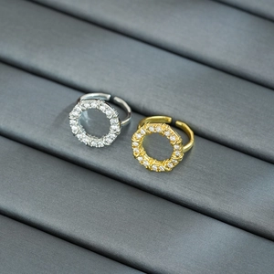 Close-up of open-adjustable gold and silver rings with cubic zirconia inlay details