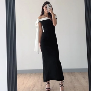 Mirror selfie showing fit of an off-shoulder bodycon dress with black and white contrast