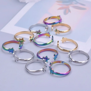 Macro view of adjustable star-shaped stainless steel rings in silver, gold and rainbow