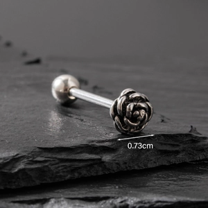 Barbell tongue ring with a 0.73cm vintage silver rose flower on dark slate background