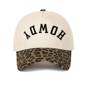 Close-up of HOWDY embroidery on cream canvas crown with leopard print brim baseball cap
