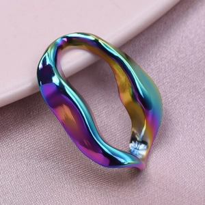 Macro shot of an irregular wavy ring with rainbow metallic luster and smooth texture