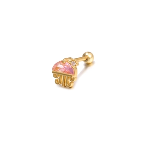 Macro shot of gold jellyfish cartilage earring with pink gemstone and zircon detail