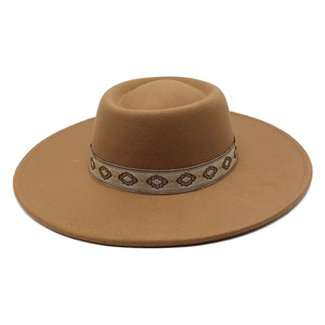 Detail of camel wool felt fedora featuring a vintage geometric woven band decoration