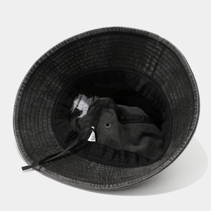 Detail view of cotton bucket hat interior showing sweatband and breathable metal eyelet