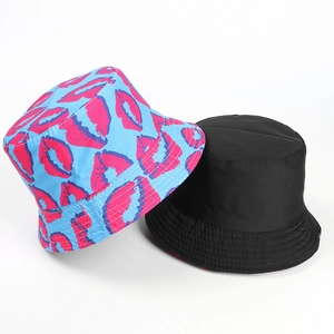 Detail view of reversible bucket hat with pink lip print and classic solid black side