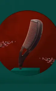 Deep brown ergonomic hair massage comb with teardrop handle on a decorative pedestal