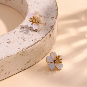 Macro detail of cherry blossom studs in 18K gold finish with natural mother of pearl petals