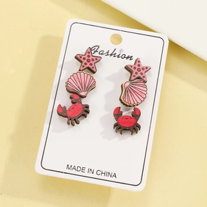 Close-up of wooden marine earrings set featuring starfish shell and crab designs
