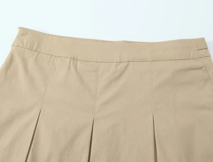 Detail of khaki pleated cargo skort showing waist stitching and twill fabric texture
