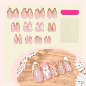 Almond press-on nails with 3D white flowers, pearls, and gold accents in pink and white