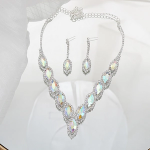 Macro shot of silver bridal jewelry set with colorful crystals in V-shaped design