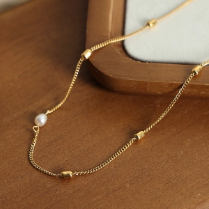 French minimalist gold titanium necklace with freshwater pearl pendant and cylinder beads