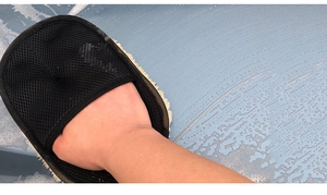 Detail showing the breathable black mesh backing of the faux wool car wash glove