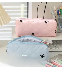 Quilted floral pencil cases in pink and blue with bow embroidery and zipper closure
