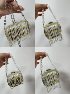 Detail of silver rhinestone fringe and beaded handle on trendy evening clutch bag