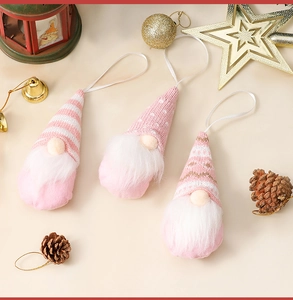 Close-up of pink knitted Christmas gnomes ornaments with plush beards and hanging strings