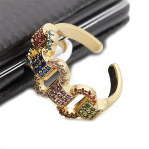 Detail of adjustable gold ring featuring micro-pave multicolor cubic zirconia stones