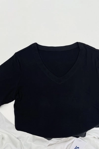 Close-up of the V-neckline on a black slim-fit cotton T-shirt with precise stitching