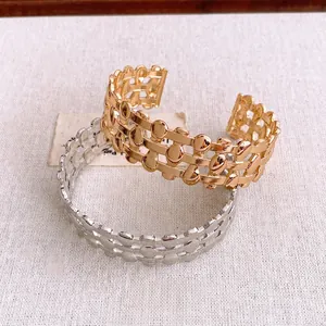 Three-layer hollow woven geometric cuff bracelets in polished gold and silver finishes