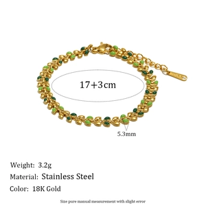 Detailed macro view of 18K gold plated leaf chain with green enamel and stainless steel links