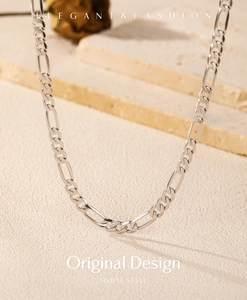 Close-up of S925 sterling silver Figaro chain necklace showing elegant metallic texture