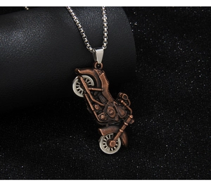 Detailed macro view of vintage bronze motorcycle pendant with silver metal wheels