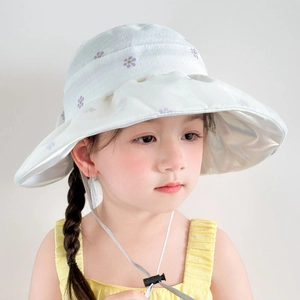 Detail of girls' sun hat with purple floral print and adjustable windproof strap