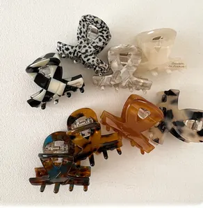 Detail of assorted acetate claw clips in checkered, leopard, and marble patterns