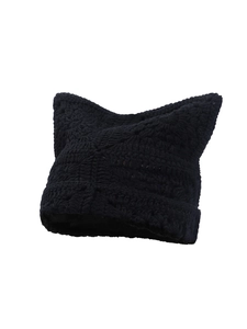 Close-up of black crochet knit cat ear beanie showing detailed texture and handmade yarn pattern