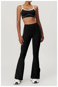 Detail of high-waist flared yoga pants and sports bra with white contrast stitching