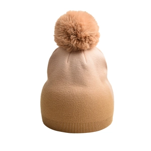 Detail der Strickmütze mit flauschigem Kunstpelz-Bommel und Farbverlauf-Rippenmuster