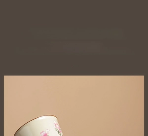 Detail of hand-painted pink flower ceramic cup for tea and daily use with smooth glaze