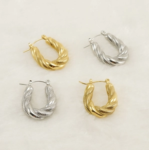 Close-up of twisted rope texture on gold and silver U-shaped hoop earrings