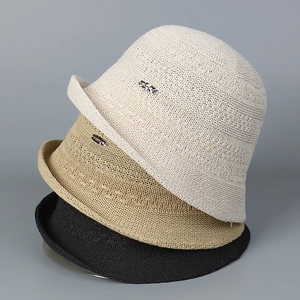 Detail view of breathable hollow-out knit bucket hats in beige, khaki, and black colors