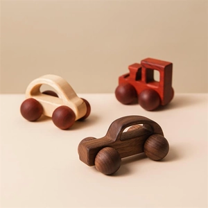 Detailed view of three mini wooden toy cars in walnut and natural wood with wood grain