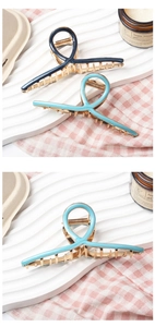 Detail of large alloy hair claw clips with colorful oil drip ribbons and spring mechanism