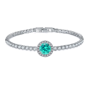 Detail of the halo setting with a round teal gemstone and sparkling diamond chain