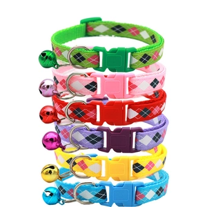 Detailed view of six colorful pet collars with paw prints and matching bells in a vertical stack