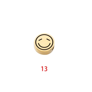 Detailed view of a gold-plated round charm bead with laser-engraved smiley face for DIY jewelry