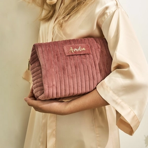 Detail of pink velvet makeup bag with gold zipper and personalized Amelia name tag