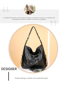 Detail of black soft leather shoulder bag with multiple zippered pockets and metal hardware