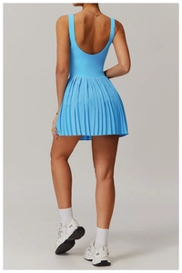 Detail of light blue tennis dress featuring backless U-shape and pleated skirt hemline