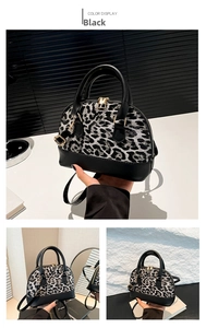 Close-up of leopard print shell bag with black leather accents and gold hardware